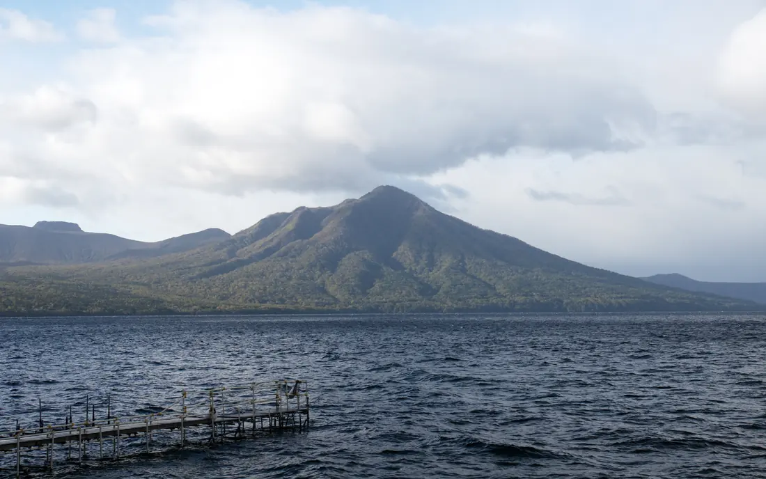 Mount Fuppushi across Lake Shikotsu, a jetty in the foreground