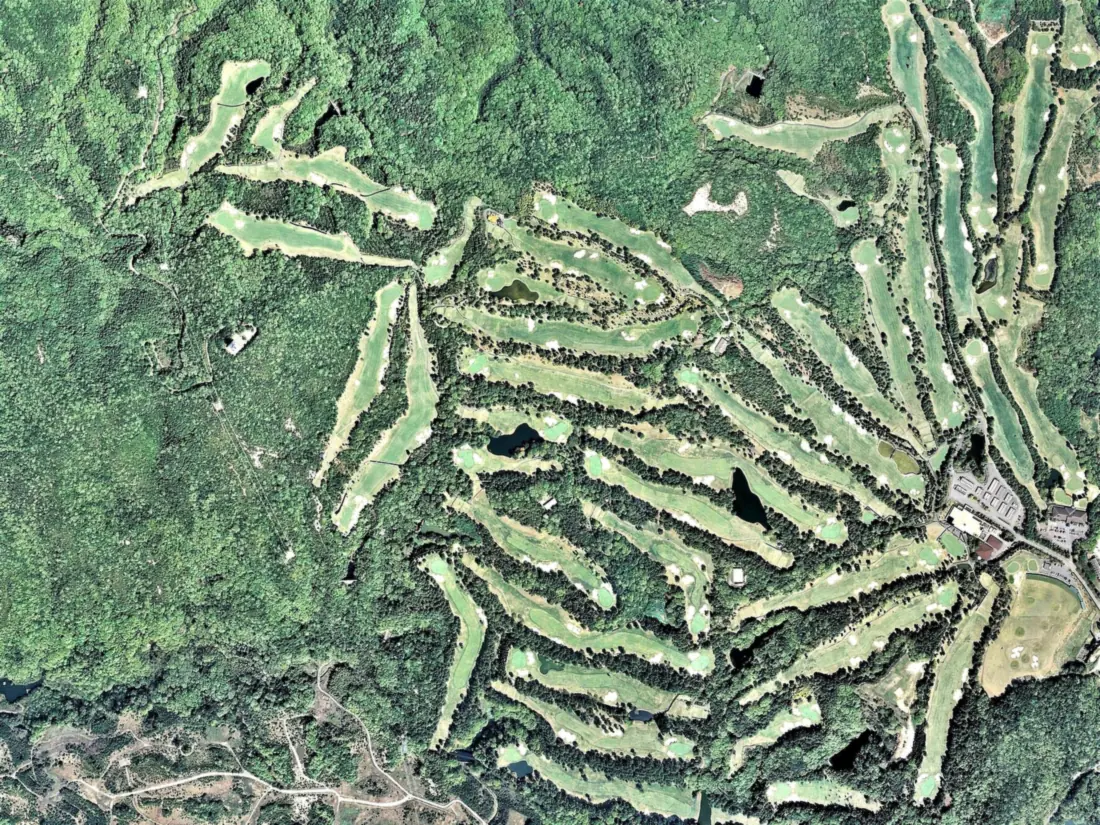 Aerial survey photograph of Rokko Kokusai Golf Club, its holes threading the forested ridges above Kobe