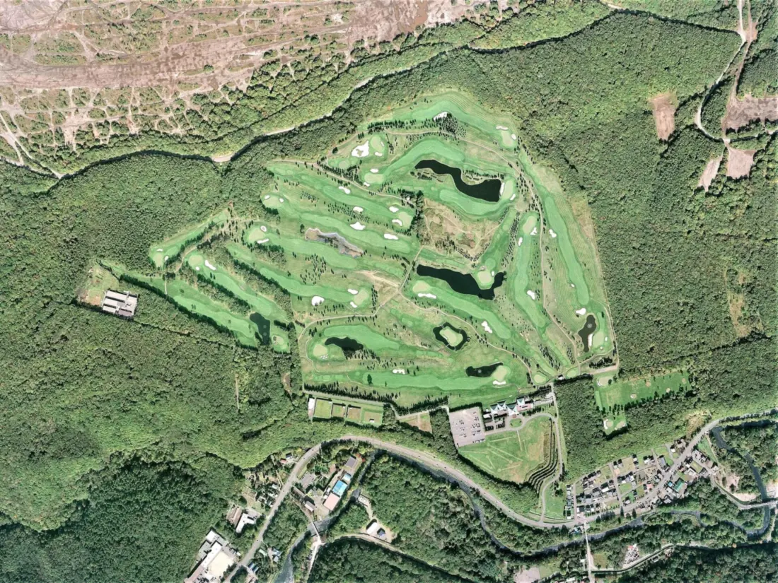 Aerial survey photograph of The North Country Golf Club, its fairways cut through woodland outside Chitose, Hokkaido
